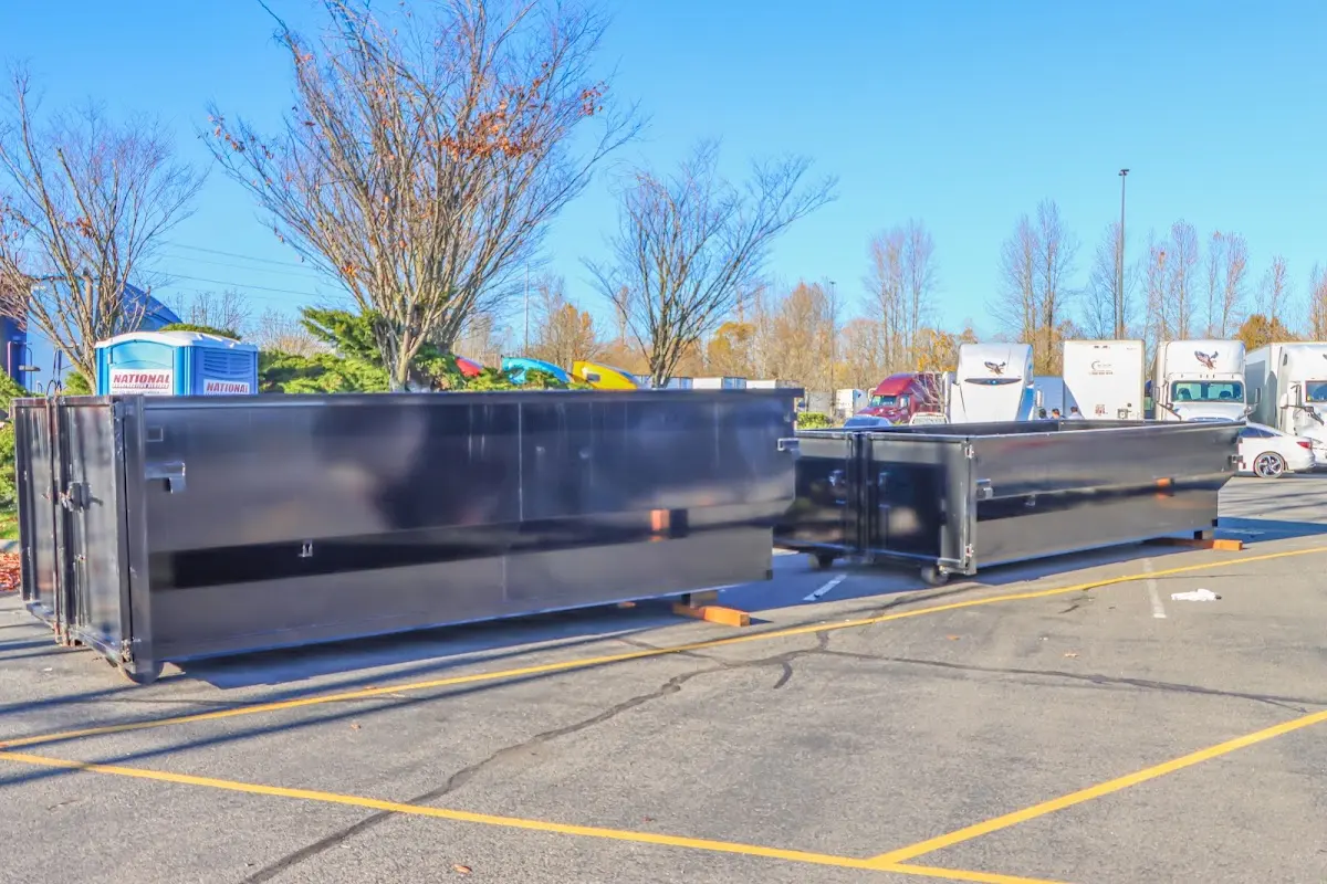 Professional dumpster rental service with roll-off container on residential driveway in Lakemoor